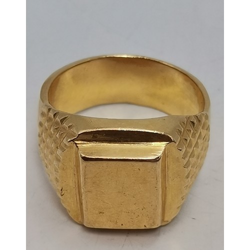 549 - A gent's large yellow metal signet ring, the raised rectangular matrix to a cushion mount, with tape... 