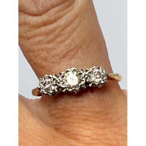 550 - A three-stone ring, set with graduated round white stones, stamped '18CT & PLAT' to shank. Ring size... 