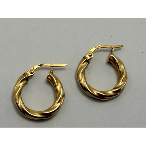  A small group of 9 carat gold jewellery comprising one pair of small hoop earrings, one pair of pend... 