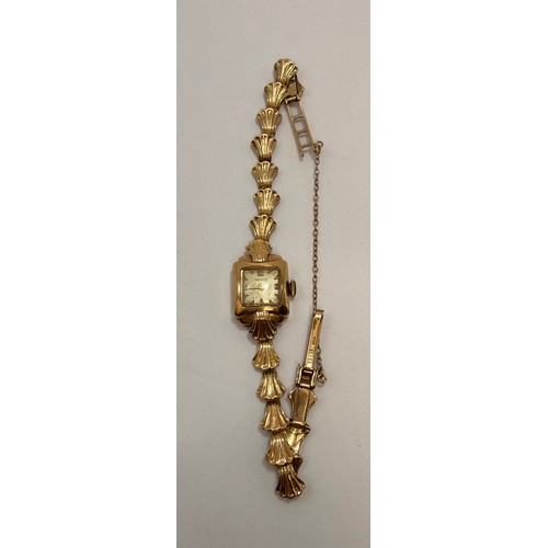  A lady's 9 carat gold fancy link bracelet watch, the square dial signed HELVETIA, with gilt metal Ar... 