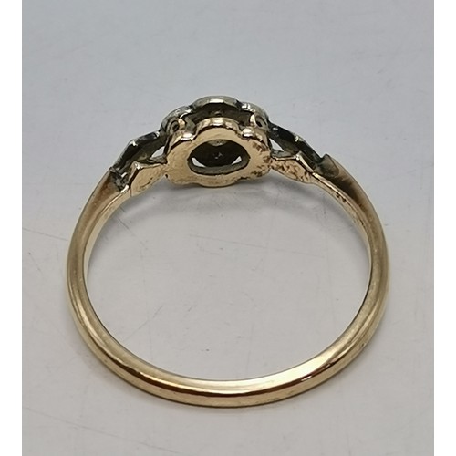  Two 9 carat gold white stone rings, the first a flowerhead cluster of graduated round stones in a ra... 