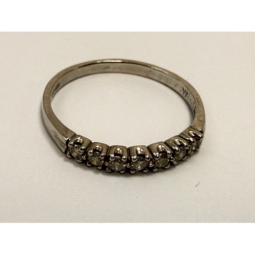  A platinum half-hoop ring, claw-set with seven round white stones, stamped 950 and hallmarked London... 