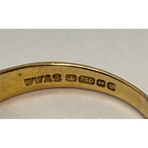 574 - An 18 carat gold three-stone ring, the flat top set with a central round blue stone flanked by an il... 