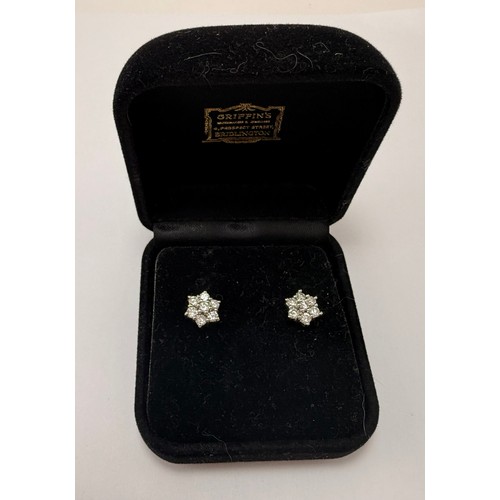  A pair of 18 carat gold and white gold diamond cluster stud earrings, six-pointed stars, each set wi... 