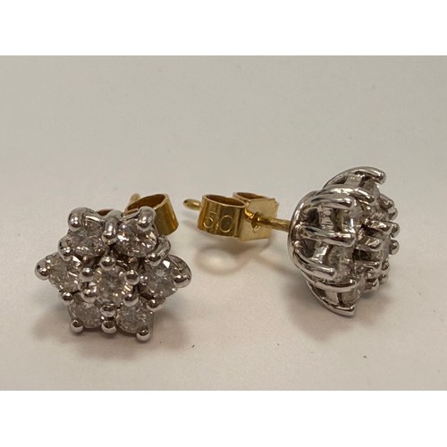  A pair of 18 carat gold and white gold diamond cluster stud earrings, six-pointed stars, each set wi... 