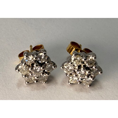  A pair of 18 carat gold and white gold diamond cluster stud earrings, six-pointed stars, each set wi... 