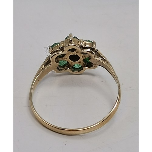 576 - Two 9 carat gold green gemstone rings, the first a flowerhead cluster, hallmarked 375, ring size R1/... 