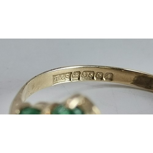 576 - Two 9 carat gold green gemstone rings, the first a flowerhead cluster, hallmarked 375, ring size R1/... 