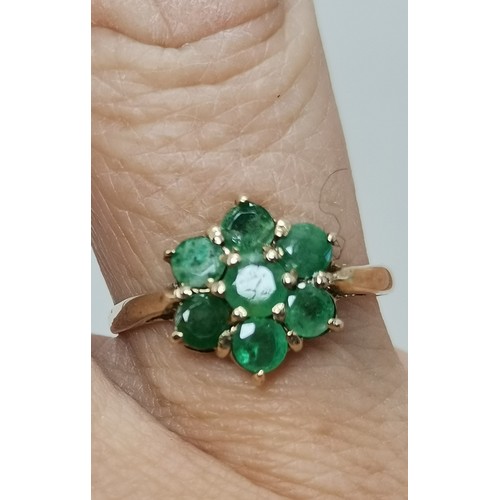 576 - Two 9 carat gold green gemstone rings, the first a flowerhead cluster, hallmarked 375, ring size R1/... 
