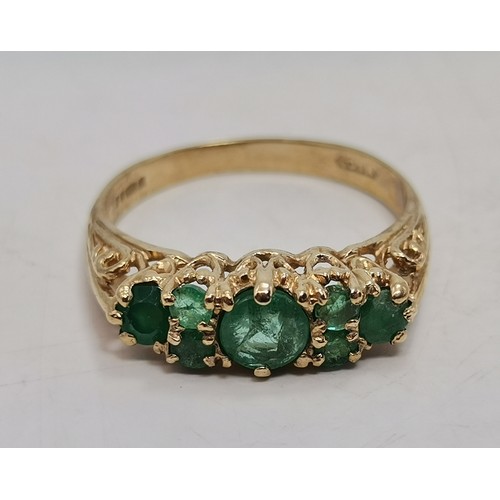 576 - Two 9 carat gold green gemstone rings, the first a flowerhead cluster, hallmarked 375, ring size R1/... 