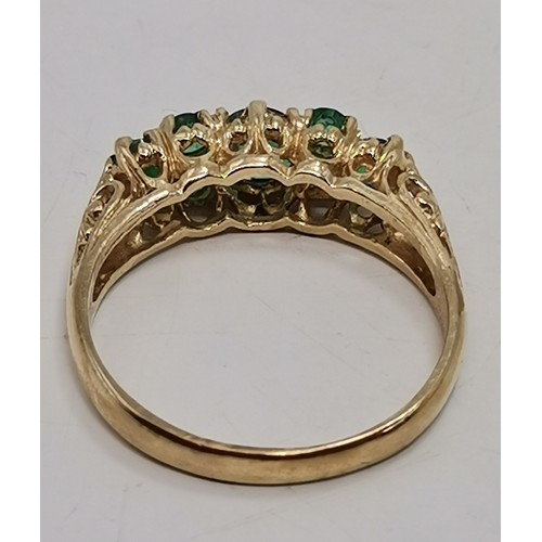 576 - Two 9 carat gold green gemstone rings, the first a flowerhead cluster, hallmarked 375, ring size R1/... 