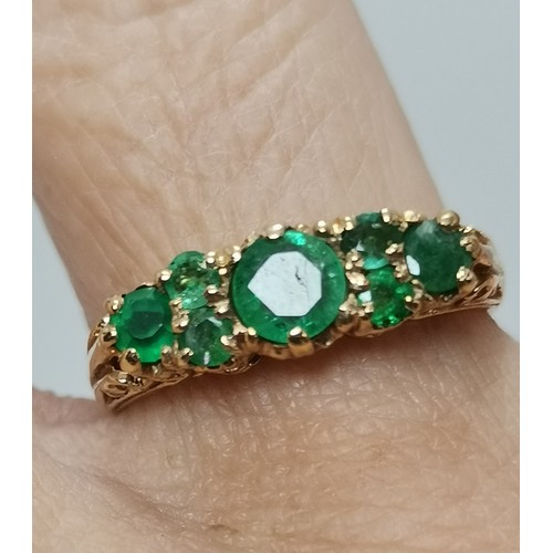 576 - Two 9 carat gold green gemstone rings, the first a flowerhead cluster, hallmarked 375, ring size R1/... 