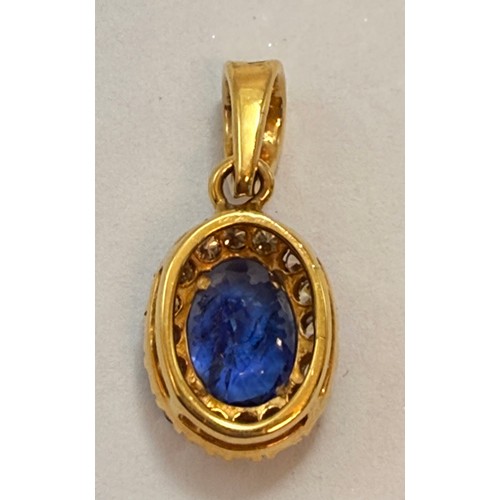  A Tanzanite and diamond cluster pendant, the claw-set oval blue-violet Tanzanite enclosed by a halo ... 