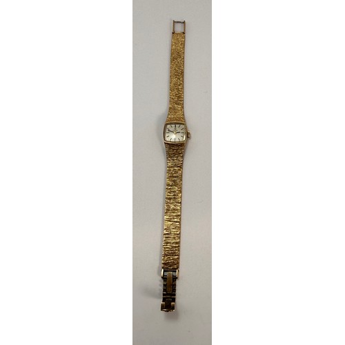  A lady's 9 carat gold wristwatch to an articulated textured bracelet strap, the square dial signed O... 