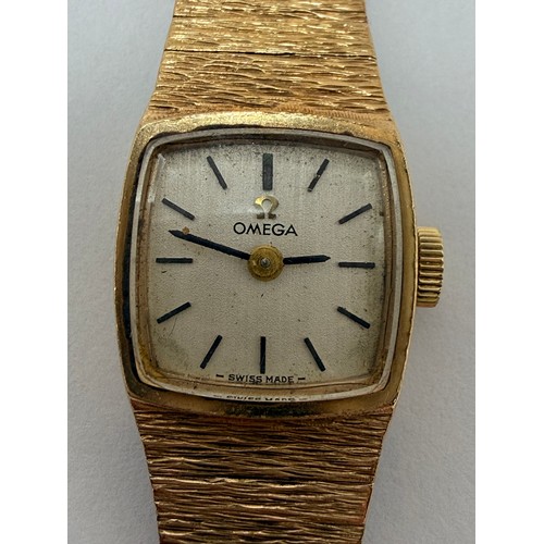  A lady's 9 carat gold wristwatch to an articulated textured bracelet strap, the square dial signed O... 