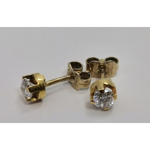 587 - Three pairs of gold-mounted earrings comprising a pair of diamond studs, hallmarked 750; a pair of k... 