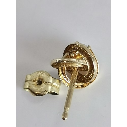 587 - Three pairs of gold-mounted earrings comprising a pair of diamond studs, hallmarked 750; a pair of k... 