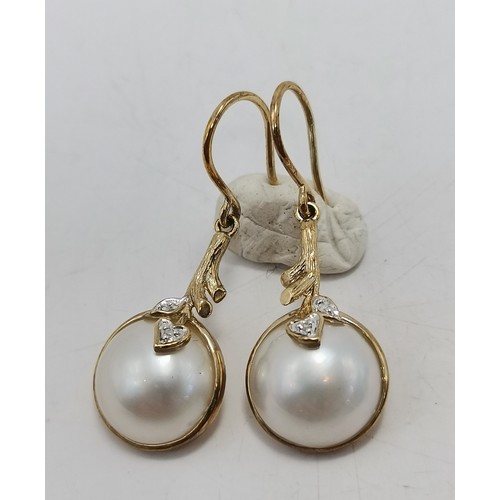 587 - Three pairs of gold-mounted earrings comprising a pair of diamond studs, hallmarked 750; a pair of k... 