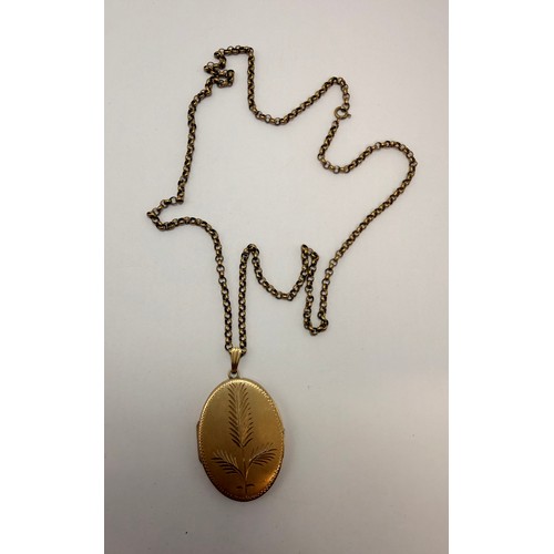 588 - A large 9 carat gold locket pendant, oval, engraved to front with stylised foliage, hallmarked Birmi... 
