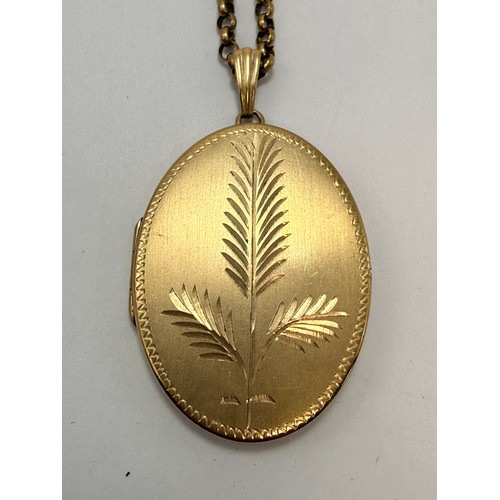 588 - A large 9 carat gold locket pendant, oval, engraved to front with stylised foliage, hallmarked Birmi... 