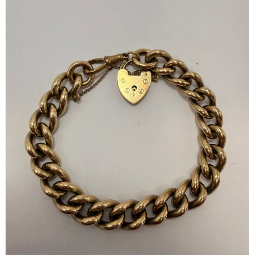 589 - A substantial 9 carat gold curb-link bracelet with heart padlock and dog clip, hallmarked London 197... 