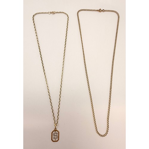  An Italian gold pendant, openwork elongated octagonal with white metal initial 'S' set with white st... 
