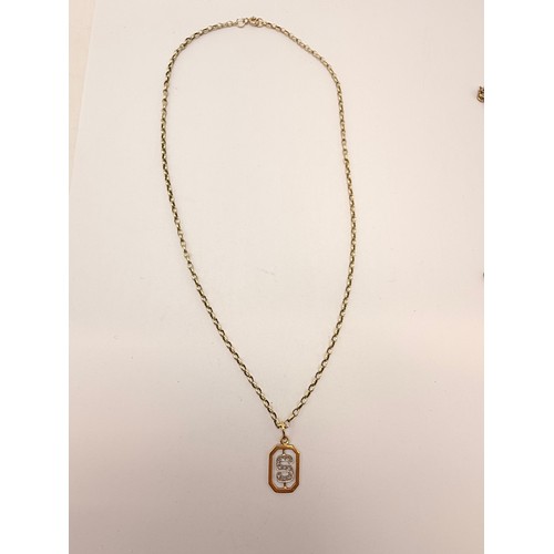 An Italian gold pendant, openwork elongated octagonal with white metal initial 'S' set with white st... 