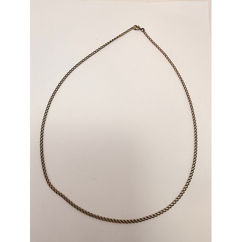  An Italian gold pendant, openwork elongated octagonal with white metal initial 'S' set with white st... 