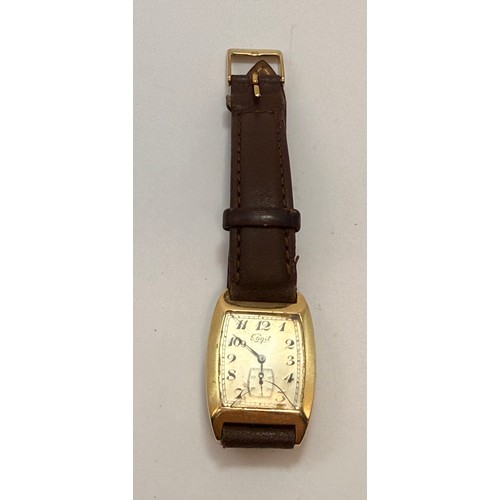  A 14 carat gold-cased wristwatch, c.1920s, the silvered cushion dial signed Sagit, with blue enamel ... 