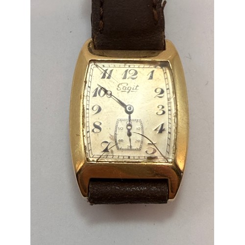  A 14 carat gold-cased wristwatch, c.1920s, the silvered cushion dial signed Sagit, with blue enamel ... 