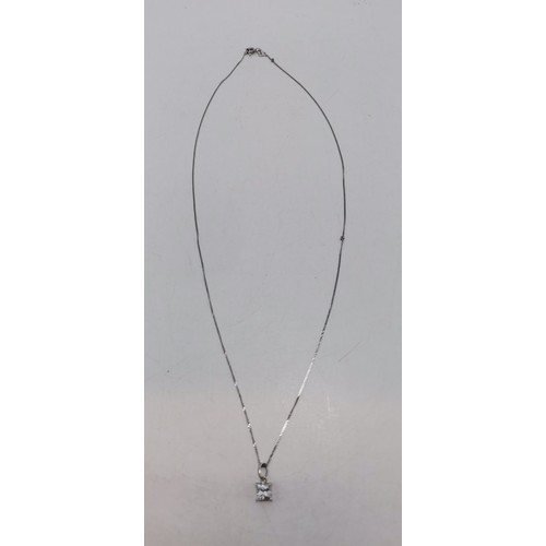 601 - A white gold fine trace chain necklace, stamped 375 and 9k to clasp, hung with a white metal-mounted... 