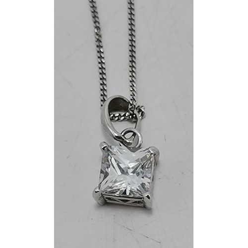 601 - A white gold fine trace chain necklace, stamped 375 and 9k to clasp, hung with a white metal-mounted... 