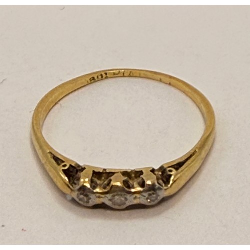  An 18 carat gold and platinum three-stone ring, the carved and pierced gallery mount illusion-set wi... 