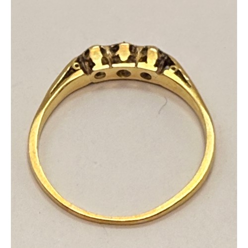  An 18 carat gold and platinum three-stone ring, the carved and pierced gallery mount illusion-set wi... 