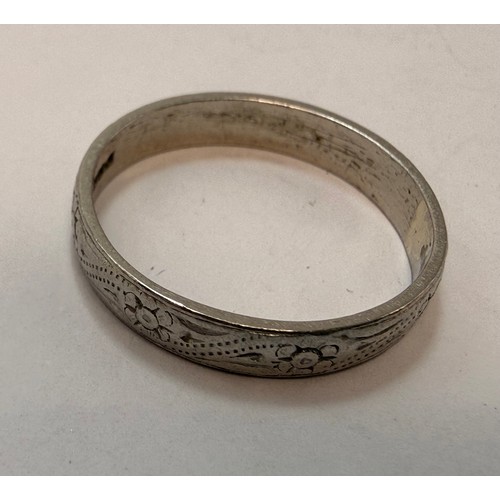 606 - A platinum wedding band, carved with flowerheads and rope-twist decoration, hallmarked Sheffield 198... 