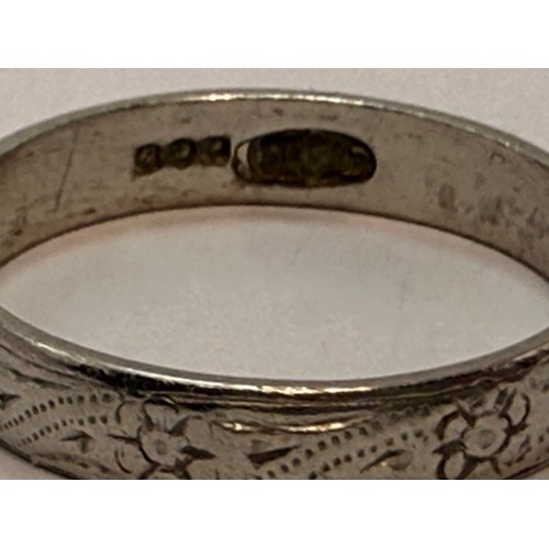 606 - A platinum wedding band, carved with flowerheads and rope-twist decoration, hallmarked Sheffield 198... 
