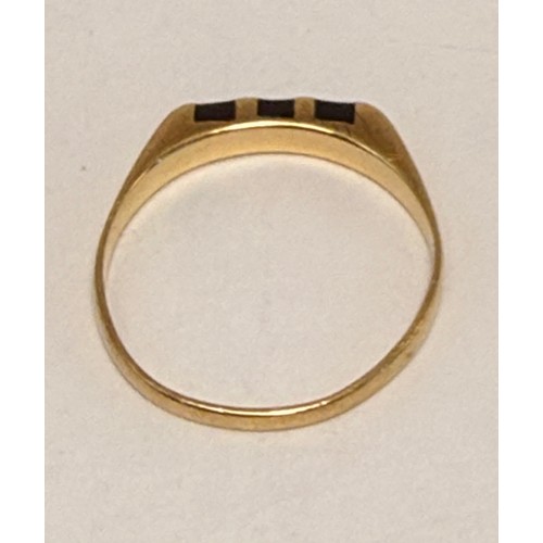 608 - A gold and onyx ring, the flat-top mount set with three black bands, (marks rubbed). Ring size L1/2,... 