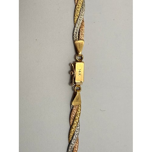  An Italian tri-coloured gold jewellery suite comprising a flat link braided necklace and bracelet, t... 