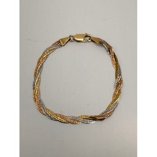  An Italian tri-coloured gold jewellery suite comprising a flat link braided necklace and bracelet, t... 