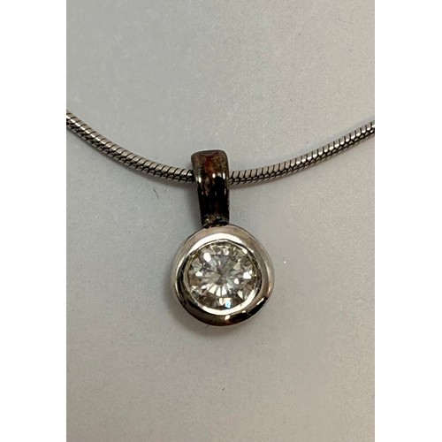  An 18 carat white gold diamond pendant necklace, the round stone in an openwork pendant mount, both ... 