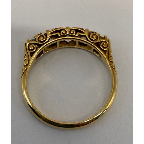 622 - An 18 carat gold five-stone ring, the graduated round white stones set with four pairs of accent sto... 