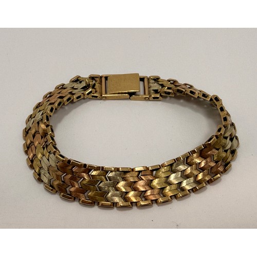  A 9 carat tri-colour gold modernist bracelet, with textured chevron links, hallmarked Birmingham 197... 