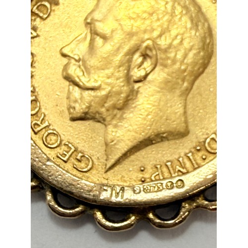 634 - A George V half sovereign, 1915, to a 9 carat gold loose pendant mount hallmarked London 1971, on a ... 