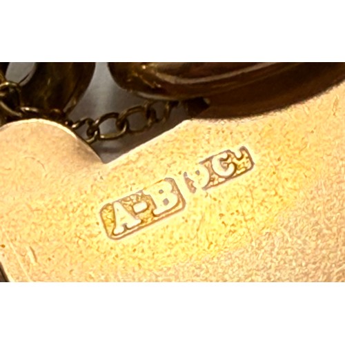  A 9 carat gold charm bracelet with heart padlock clasp, hung with twelve assorted charms, the curb l... 