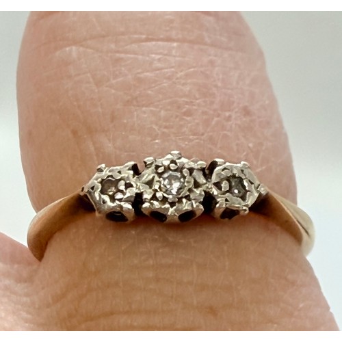 642 - A 9 carat gold wedding band, hallmarked Birmingham 1988, ring size S1/2; together with a three-stone... 
