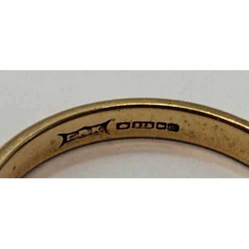 642 - A 9 carat gold wedding band, hallmarked Birmingham 1988, ring size S1/2; together with a three-stone... 