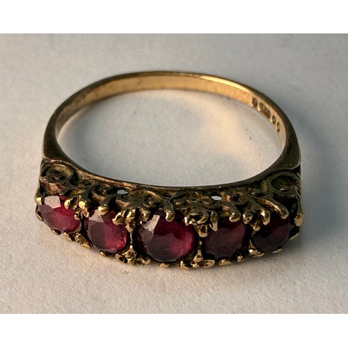 A 9 carat gold five-stone ring, the graduated round pink stones set to a carved and pierced gallery ... 