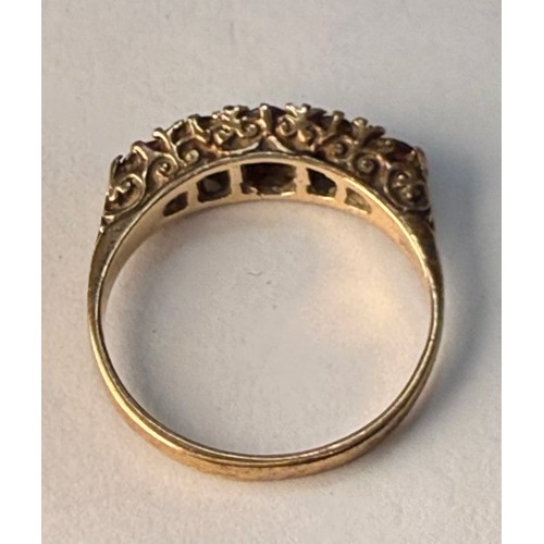 A 9 carat gold five-stone ring, the graduated round pink stones set to a carved and pierced gallery ... 
