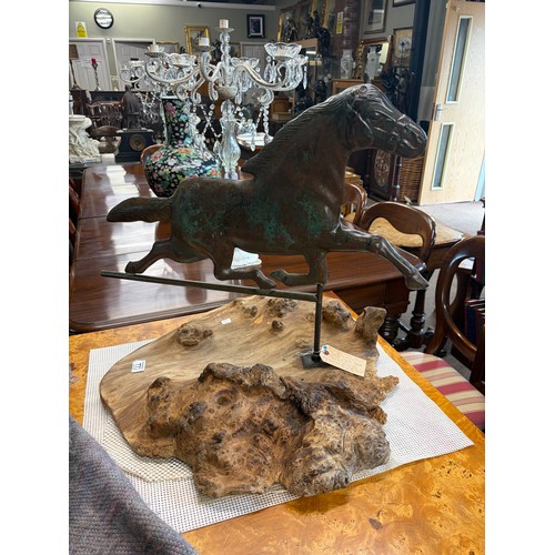 772 - A patinated bronze weather vane in the form of a horse on a driftwood base 58cm high

Good: In good ... 