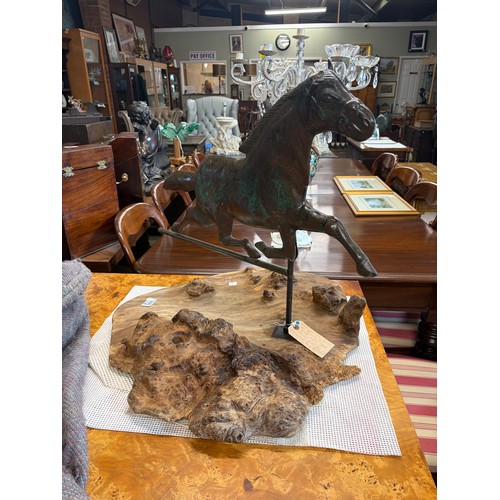 772 - A patinated bronze weather vane in the form of a horse on a driftwood base 58cm high

Good: In good ... 